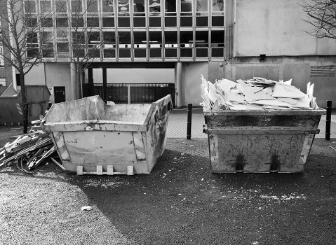 A skip container being delivered to a residential property in Feltham