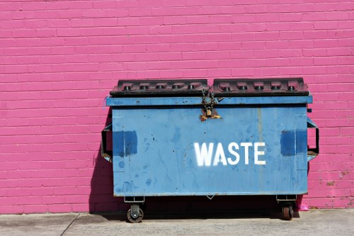 Image of a collection vehicle beside a skip during pickup
